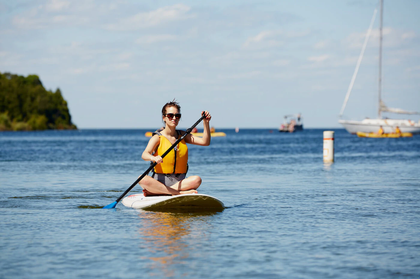A woman paddle boards in Peninsula State Park in Door County. The county's tourism bureau expects a busy Memorial Day weekend as people begin to travel again after a year of staying put during the pandemic. (Photo courtesy of John Nienhuis/Destination Door County)
