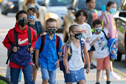 Students, some wearing protective masks, arrive for the first day of school at a Florida elementary school. (AP Photo/Chris O'Meara, File)