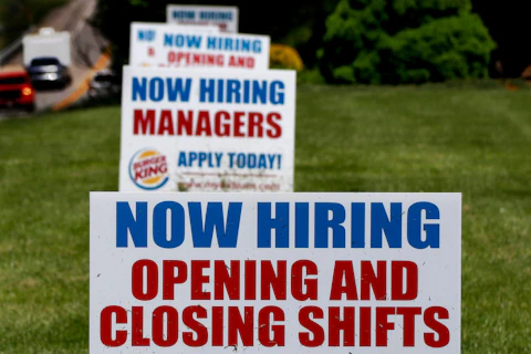 A row of signs advertising jobs are posted in front of a Burger King restaurant, Thursday, May 21, 2020, in Harmony, Pa. The number of Americans applying for unemployment benefits in the two months since the coronavirus took hold in the U.S. has swelled to nearly 39 million, the government reported Thursday, even as states from coast to coast gradually reopen their economies and let people go back to work. (AP Photo/Keith Srakocic)