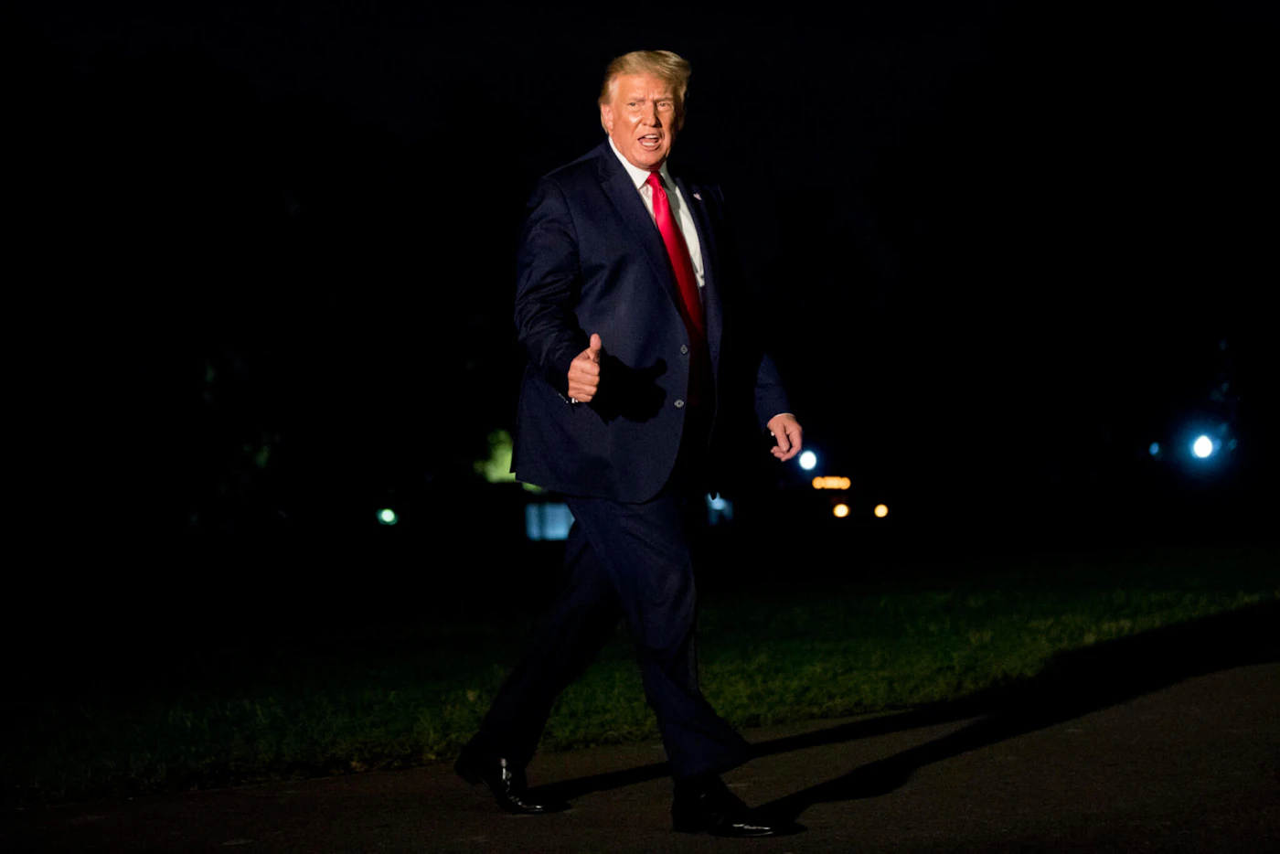 President Donald Trump gives a thumbs-up to members of the media as he walks across the South Lawn as he arrives at the White House in Washington, Sunday, Aug. 9, 2020, after returning from Morristown, N.J. (AP Photo/Andrew Harnik)