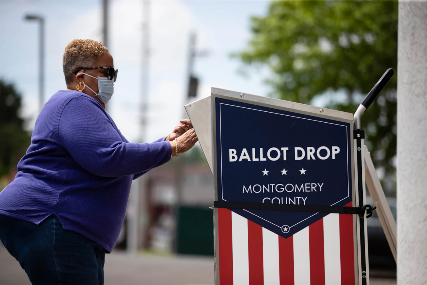 A voter drops off their mail-in ballot prior to the primary election, in Willow Grove, Pa., Wednesday, May 27, 2020. (AP Photo/Matt Rourke)