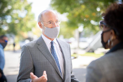 Gov. Tom Wolf speaks to someone at an event in York County in October. (Flickr/Office of Gov. Tom Wolf)