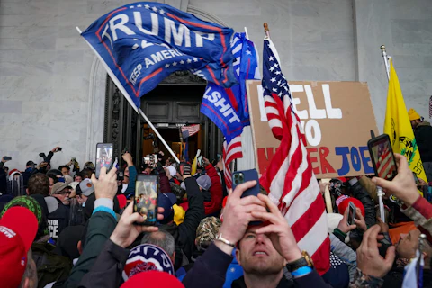 In this Jan. 6, 2021, file photo, Trump supporters gather outside the Capitol in Washington. Several of those who attacked the Capitol have been charged, including Robert Sanford, a former Chester Fire Department firefighter. (AP Photo/John Minchillo, File)