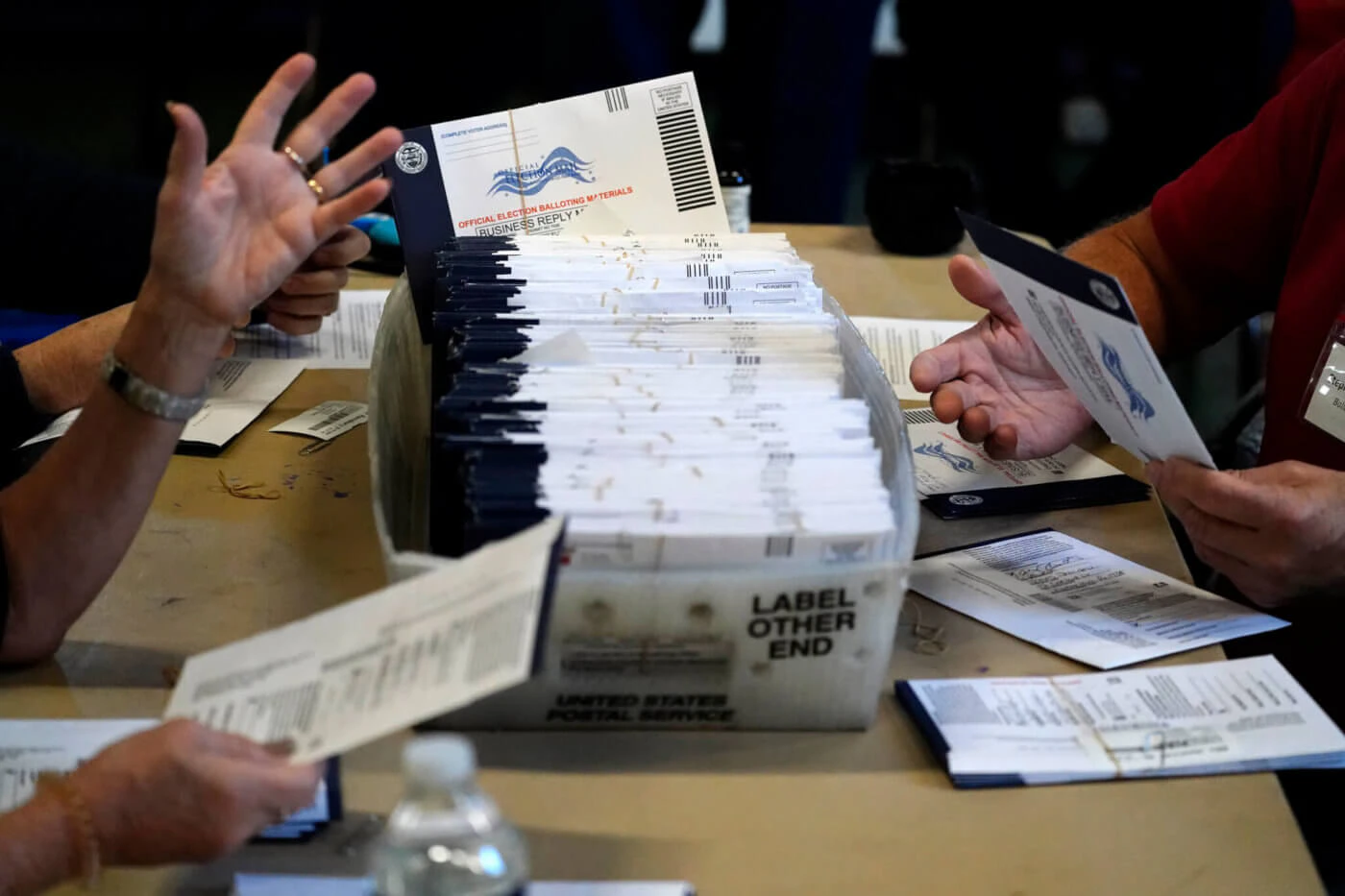 FILE - In this Wednesday, Nov. 4, 2020 file photo, Chester County election workers process mail-in and absentee ballots for the 2020 general election in the United States at West Chester University in West Chester. (AP Photo/Matt Slocum)