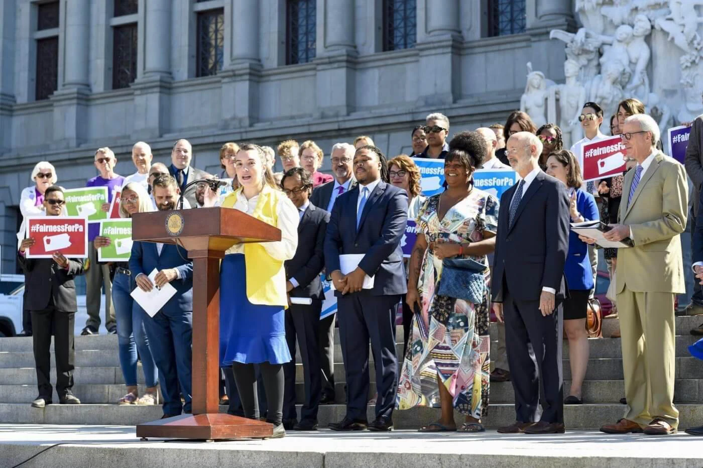 Gov. Tom Wolf and state Reps. Jessica Benham (at podium), Dan Frankel, Malcolm Kenyatta, and Brian Sims speak at a news conference to unveil the Pennsylvania Fairness Act in June. The bill, which would ban discrimination against LGBTQ communities, has been sitting in committee for months. (Courtesy of Pennsylvania House of Representatives)