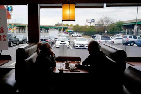 FILE - Customers sit in a booth at the Penrose Diner, Tuesday, Nov. 17, 2020, in south Philadelphia. Philadelphia officials announced Monday, Dec. 13, 2021 that proof of vaccination will be required starting Jan. 3 for bars, restaurants, indoor sporting events, movie theaters and other places where people eat indoors close to each other. (AP Photo/Matt Slocum, File)