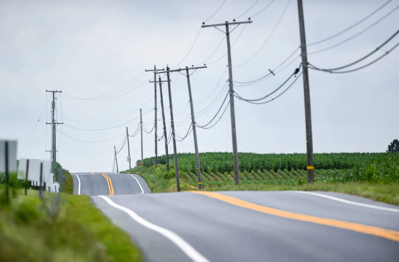 Looking down Memorial Highway (Route 662) in Oley Township, with a line of utility poles running along farm fields near Fisher's Produce in July 2021. (Reading Eagle Photo via Getty Images/Ben Hasty)