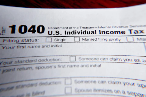 FILE - This Wednesday, Feb. 13, 2019 file photo shows part of a 1040 federal tax form printed from the Internal Revenue Service website, in Zelienople, Pa.  As the income tax filing deadline approaches, taxpayers will be facing unexpected tax situations brought about by the turbulent events of last year. Some taxpayers might get refunds and breaks they didn’t anticipate, while others could be paying more than they set aside.  (AP Photo/Keith Srakocic, File)
