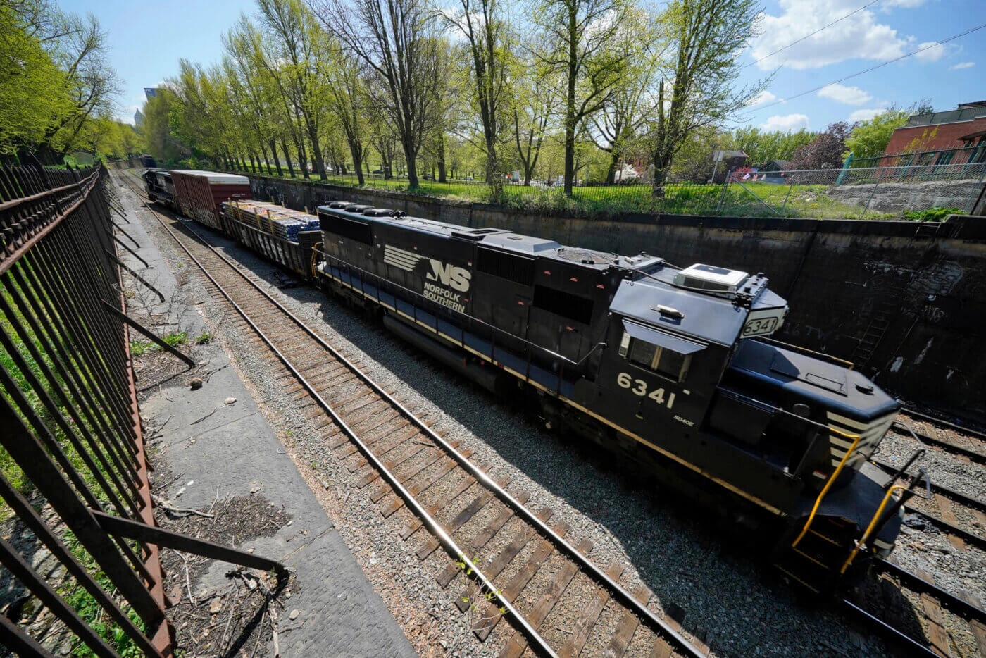 A Norfolk and Southern locomotive runs through the Northside of Pittsburgh on Monday, April 19, 2021. (AP Photo/Gene J. Puskar)