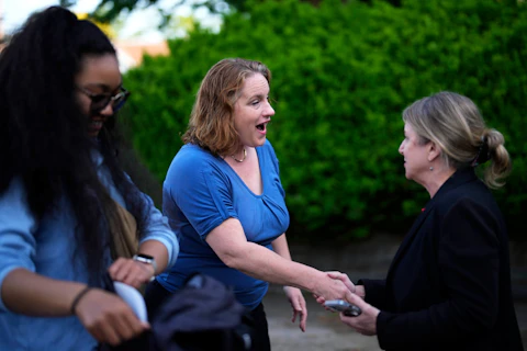Heather Boyd, center, Democratic candidate for Pennsylvania House of Representatives, greets supporters before voting at her polling place, Christ's Community Church, Tuesday, May 16, 2023, in Drexel Hill, Pa. (AP Photo/Matt Slocum)
