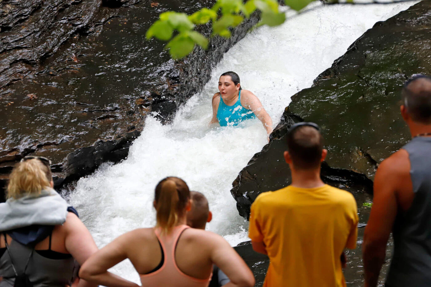 A visitor to Ohiopyle State Park in Ohiopyle, Pa. enjoys the natural waterslide at Meadow Run Sunday, May 24, 2020. (AP Photo/Gene J. Puskar)