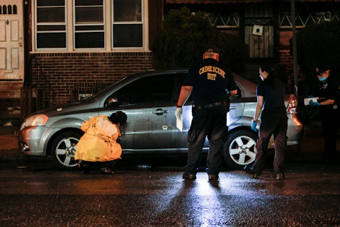 Police investigate the scene of a shooting Monday, July 3, 2023 in Philadelphia. Police say a gunman in a bulletproof vest has opened fire on the streets of Philadelphia, killing several people and wounding two boys before he surrendered to responding officers. (Steven M. Falk/The Philadelphia Inquirer via AP)