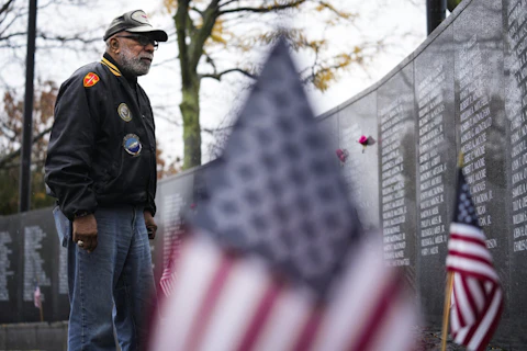 Veteran Rudy Cofield pays his respects at the Vietnam War Memorial in Philadelphia on Veterans Day, Friday, Nov. 11, 2022. (AP Photo/Matt Rourke)