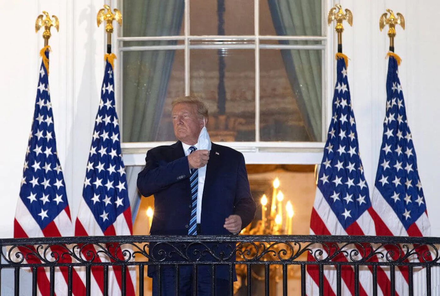 President Donald Trump removes his mask upon return to the White House from Walter Reed National Military Medical Center on October 05, 2020 in Washington, DC. Trump spent three days hospitalized for coronavirus. (Photo by Win McNamee/Getty Images)