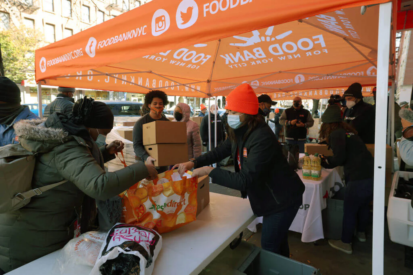 Volunteers help to give food away during a Thanksgiving food distribution event at Food Bank For New York City in the Harlem neighborhood on November 16, 2020 in New York City. Food Bank For New York City partnered with Stop & Shop and WBLS' The Steve Harvey Morning Show to give away turkeys, holiday boxes, and fresh produce to families in Harlem for Thanksgiving. (Photo by Michael M. Santiago/Getty Images)