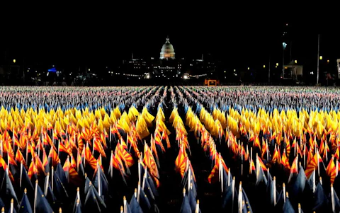 The "Field of Flags" is pictured on the National Mall as the US Capitol Building is prepared for the inauguration ceremonies for President-elect Joe Biden and Vice President-elect Kamala Harris on January 18, 2021 in Washington, DC. - President-elect Joe Biden and Vice President-elect Kamala Harris will be sworn into office January 20, 2021.