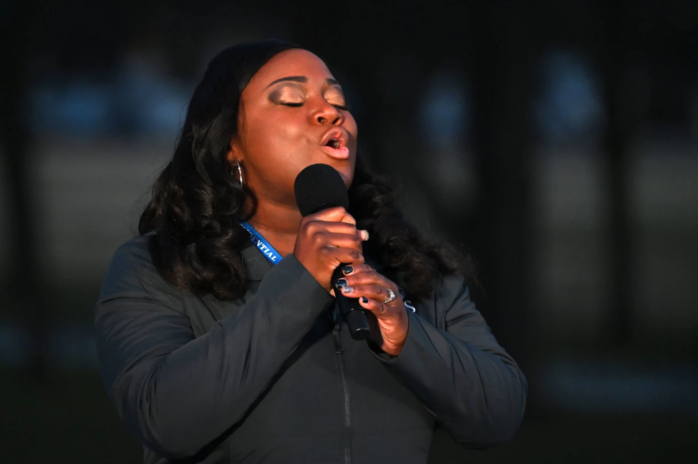 Michigan nurse Lori Marie Key of Saint Joseph Mercy Health System sings Amazing Grace during a Covid-19 Memorial at the Lincoln Memorial in Washington, DC, on January 19, 2021 to honor the lives of those lost to Covid-19. (Photo by JIM WATSON / AFP) (Photo by JIM WATSON/AFP via Getty Images)