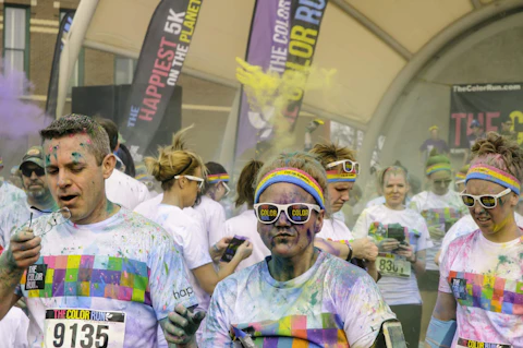 Runners enjoy fresh air in Kalamazoo after tossing packets of colored powder in the air to celebrate spring and completion of a 5K run in this Midwestern college town.