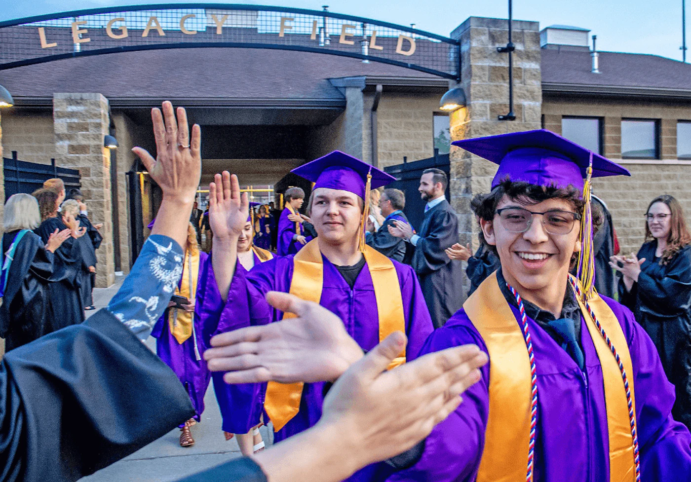 In this Daily News photo, Greenville High School seniors Joshua Jackson, left, and Thaden Ortez high-five teachers and faculty after the school's 149th commencement ceremony this year. Photo Credit: Cory Smith, The Daily News