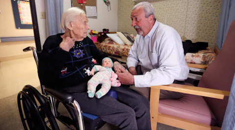 Phyllis Hotchkiss talks to her son, Glen Hotchkiss, at her nursing home in Adrian. (AP Photo/Carlos Osorio)