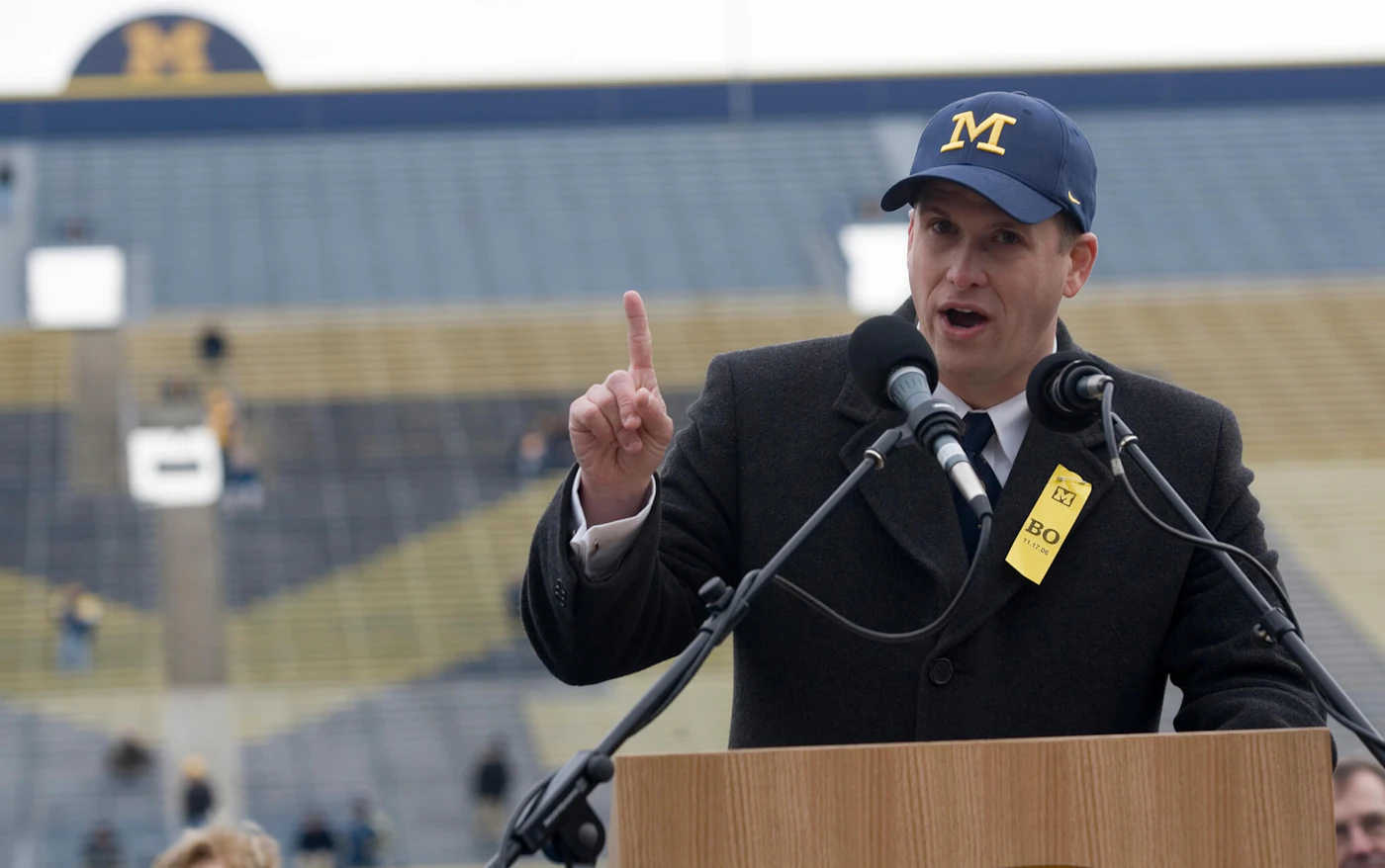 FILE - Glenn "Shemy" Schembechler III, son of former Michigan football coach Bo Schembechler, speaks at a public memorial service for his father, Nov. 21, 2006, at Michigan Stadium in Ann Arbor, Mich. Schembechler has resigned from his position with the Wolverines, with the school saying it was aware of his social media activity that may have caused “pain” in the community. (AP Photo/Tony Ding, file)