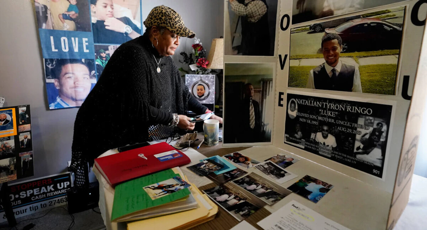 Bernice Ringo looks through photographs of her son Natalian, on Tuesday, March 28, 2023, in Detroit. (AP Photo/Carlos Osorio)