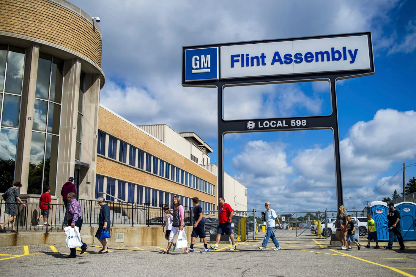 People arrive at the Flint Assembly Plant for a free tour and open house, Aug. 11, 2015, in Flint, Mich. General Motors plans to invest more than $1 billion in two Flint, Michigan manufacturing plants for the production of the next-generation internal combustion engine heavy-duty trucks. Gerald Johnson, executive vice president, Global Manufacturing and Sustainability, said Monday, June 5, 2023 that the company will build internal combustion vehicles throughout this decade, in addition to making electric vehicles. ( Jake May/The Flint Journal via AP)