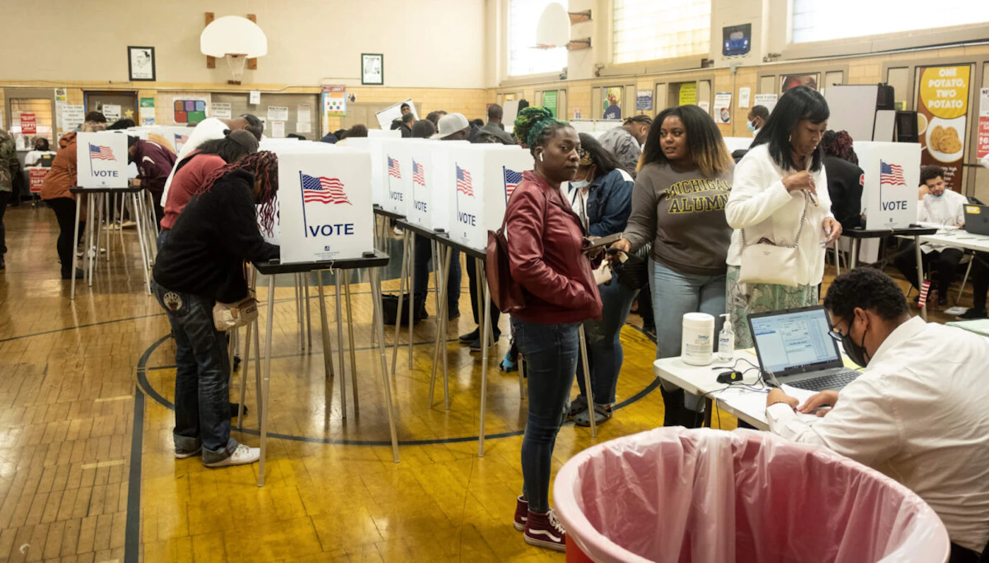 Voters check in at a polling station to cast their ballots in Detroit during the midterm elections. (Photo by Matthew Hatcher/SOPA Images/LightRocket via Getty Images)