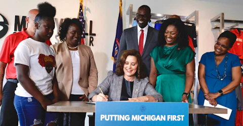 Gov. Gretchen Whitmer signs the CROWN Act into law on Thursday.