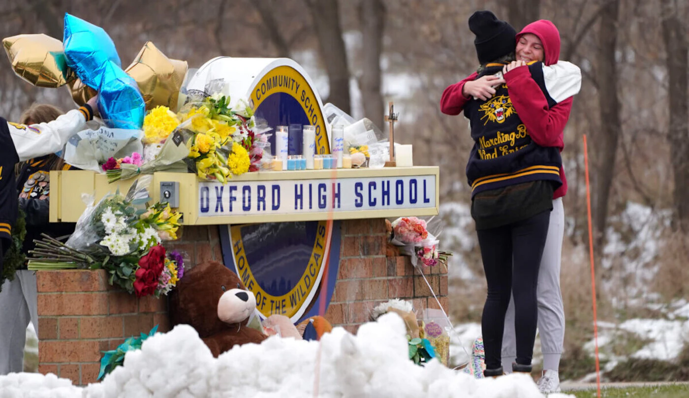 Students hug at a memorial following a shooting at Oxford High School in Oxford, Mich., Wednesday, Dec. 1, 2021. (AP Photo/Paul Sancya, File)