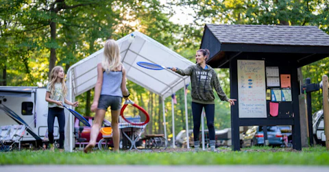 A family plays at a campsite at PJ Hoffmaster State Park. (Tyler Leiprandt and Michigan Sky Media LLC/Michigan DNR)