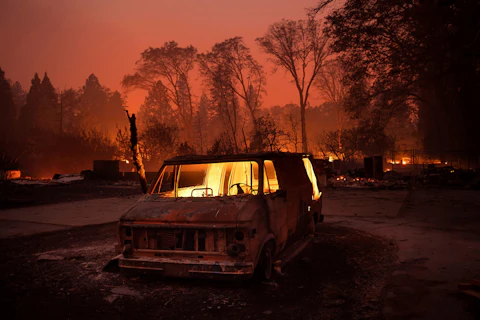 FILE - Flames burn inside a van as the Camp Fire tears through Paradise, Calif., on Thursday, Nov. 8, 2018. Currently, the Maui wildfires are the nation's fifth-deadliest on record, according to research by the National Fire Protection Association, a nonprofit that publishes fire codes and standards used in the U.S. and around the world. The Camp Fire killed 85 people and forced tens of thousands of others to flee their homes as flames destroyed 19,000 buildings in Northern California. (AP Photo/Noah Berger, File)