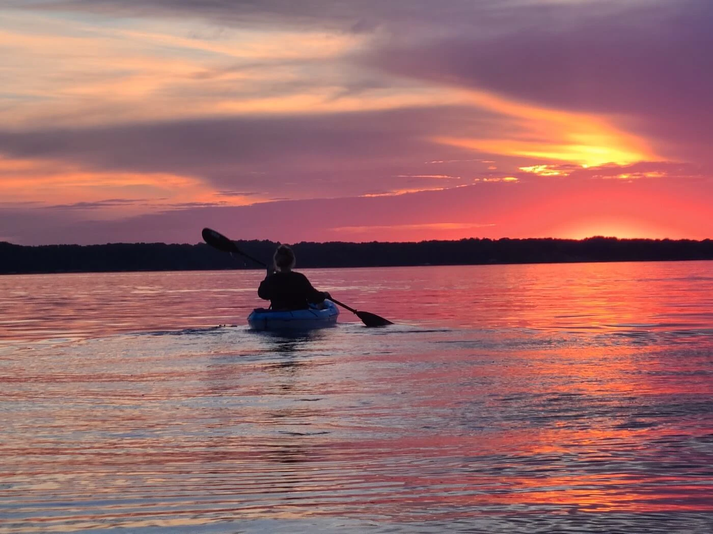 Kayaking the sunset at Torch Lake. Image via Shutterstock